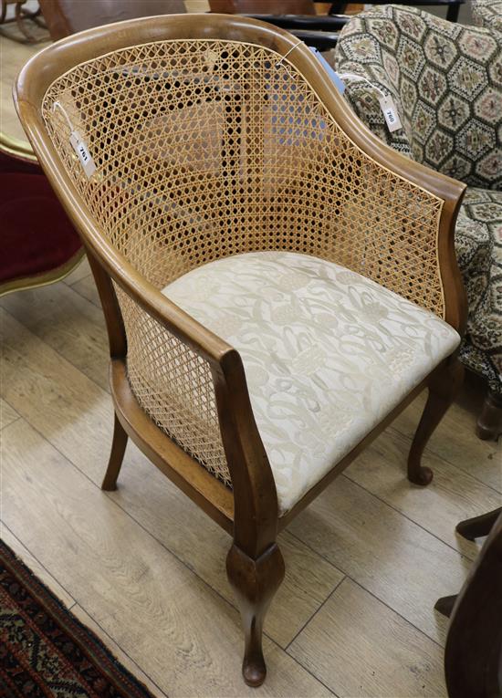 A 1920s caned mahogany tub framed chair.